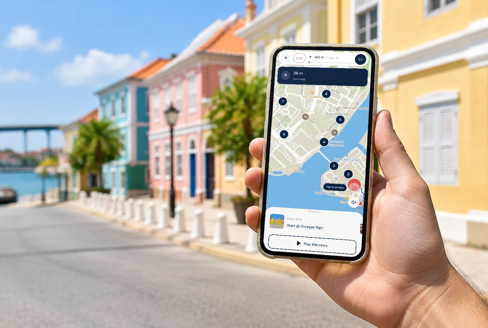 The walk app on a phone, held up in a street in Otrobanda.